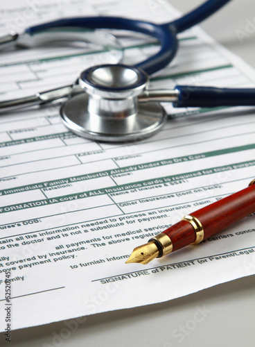 Stethoscope on medical billing statement on table