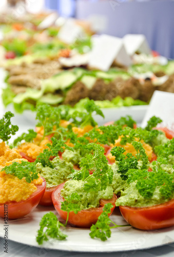 Halves tomatoes filled with green pesto and a red lentils pate.