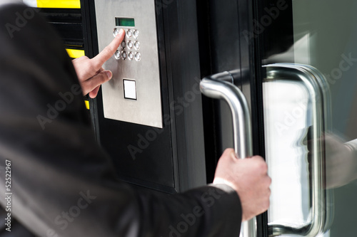Man entering security code to unlock the door