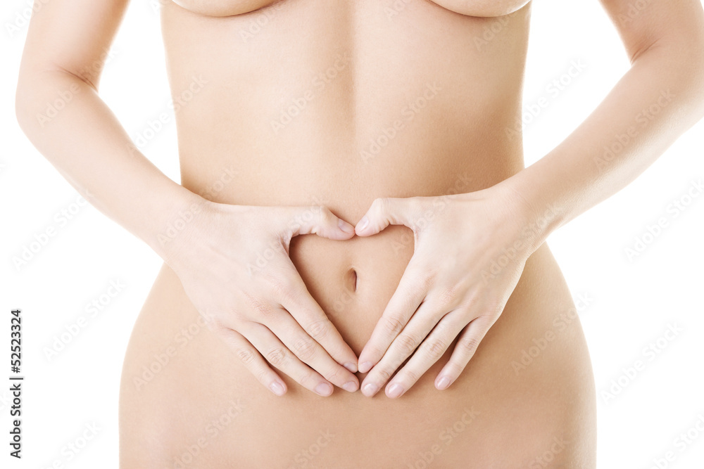 Attractive woman making heart shape on belly