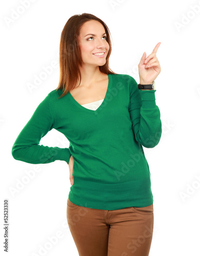 Portrait of a smiling young woman pointing up