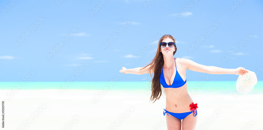 young long-haired woman in bikini enjoying her vacation