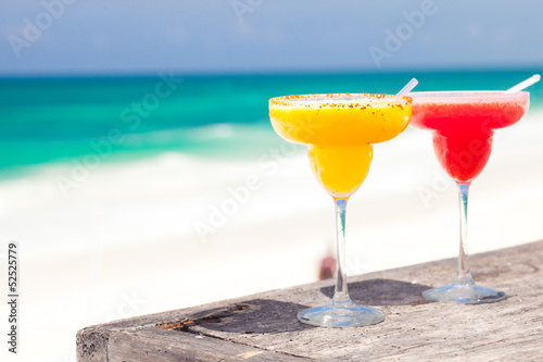 Obraz na plátně two perfect mango and strawberry margarita, beach background