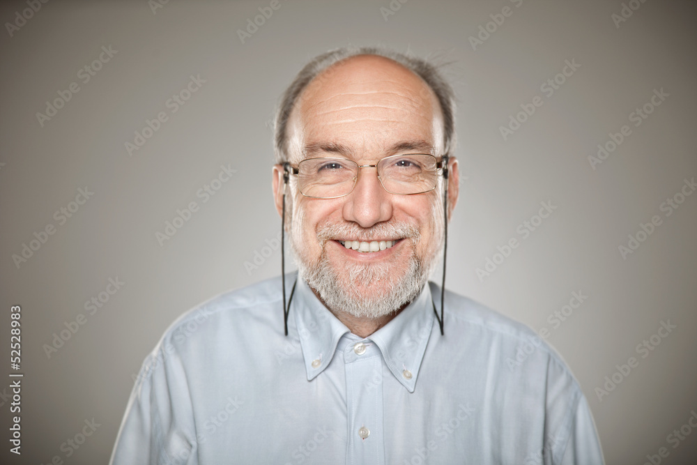 Obraz premium Portrait of old man taking glasses and smiling