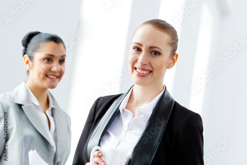 Two attractive business women smiling