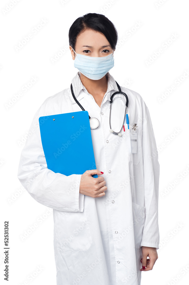 Surgeon holding clipboard. Face covered with surgical mask