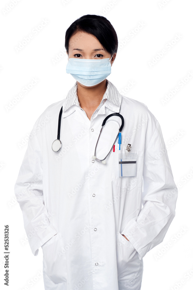 Female surgeon posing with hands in lab coat Female surgeon posing with hands in lab coat