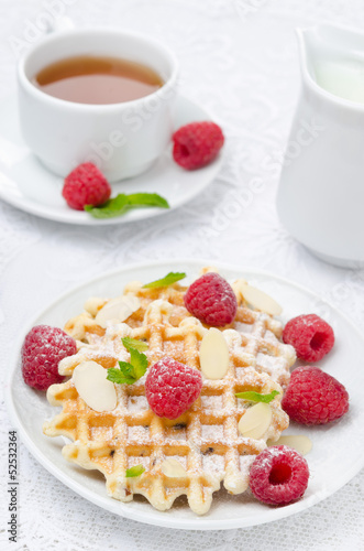 waffles with fresh raspberries, nuts and tea for breakfast