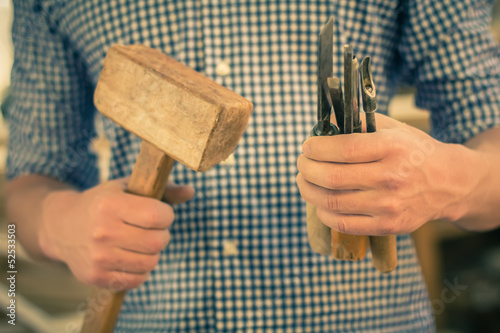  hand working in wood chisel carpenter tool hammer