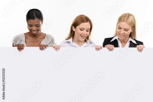 three businesswoman holding white board