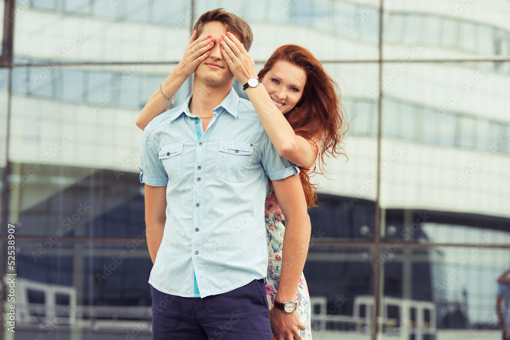 Fototapeta premium woman covering man's eyes hands