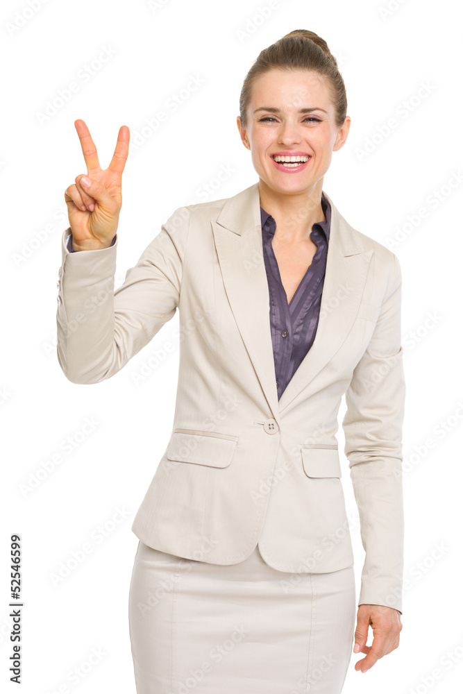 Smiling business woman showing victory gesture Smiling business woman showing victory gesture