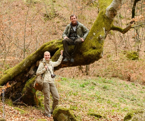 Happy smiling travellers couple in a forest