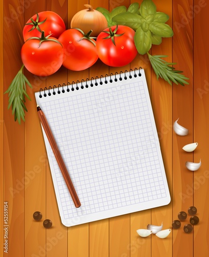 Fresh vegetables and spices on a wooden background and notebook