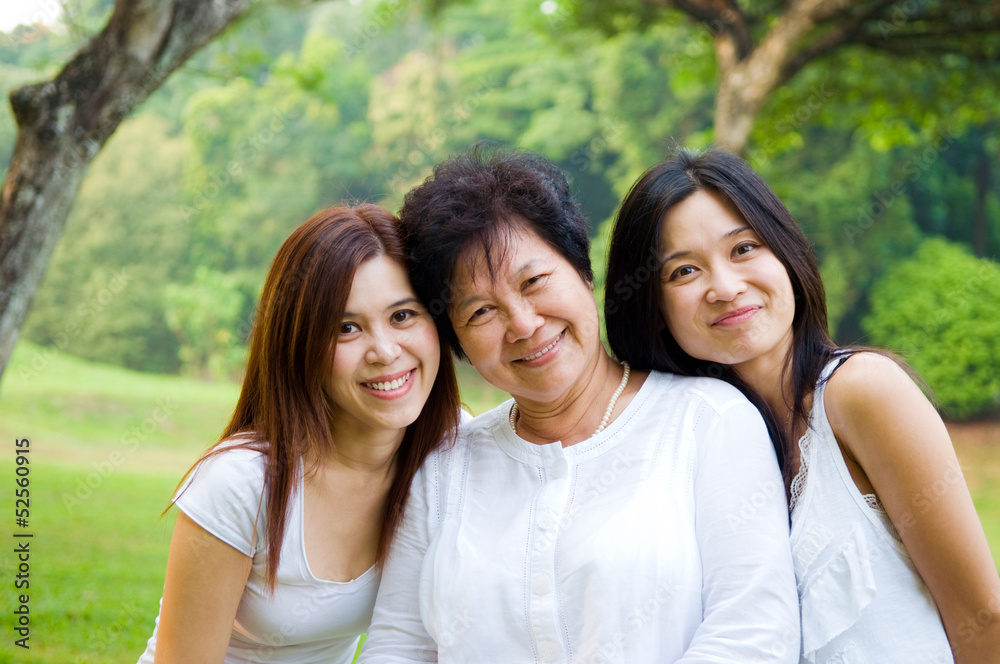 Outdoor portrait of Asian senior woman and daughter