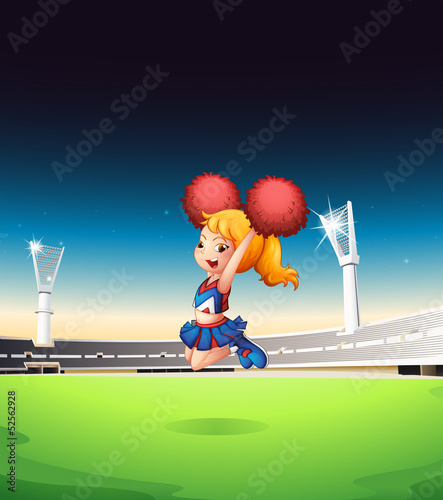 A cute cheerleader performing at the field