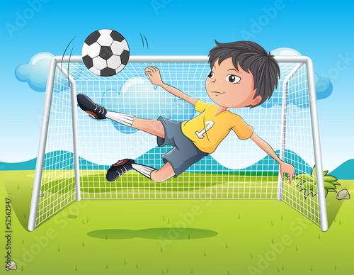 A young gentleman kicking a soccer ball