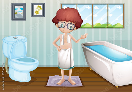 A boy with a towel at the bathroom