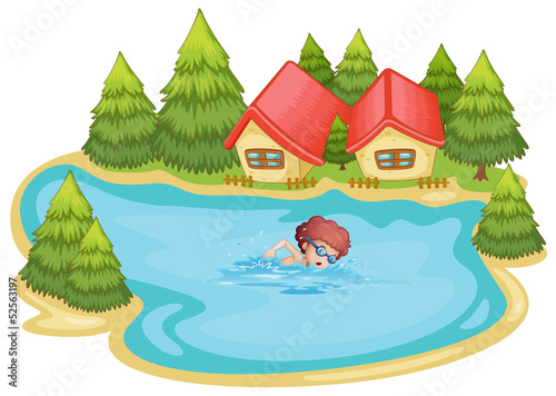 A beach near the pine trees with a boy swimming