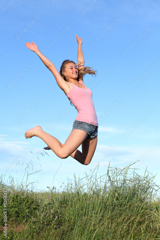 Blonde teenager girl jumping happy in the mountain Blonde teenager girl jumping happy in the mountain