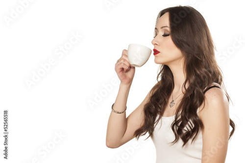 satisfied girl enjoying the smell of her coffee