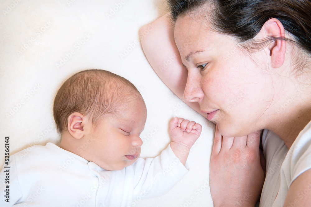 mother watching her cute baby sleeping in bed mother watching her cute baby sleeping in bed