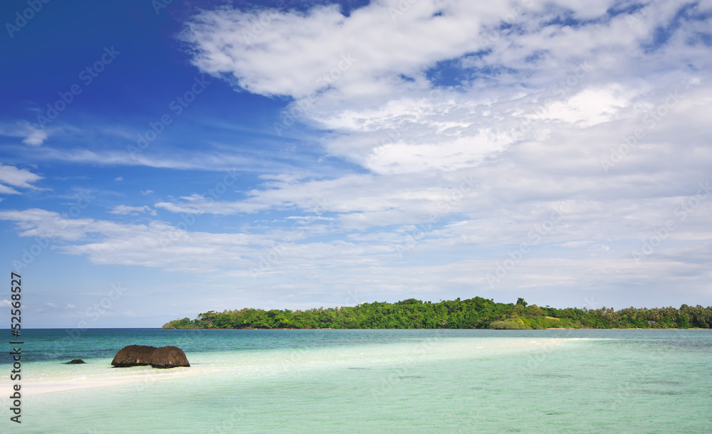 Koh Kham beach white sand with stone or rock and clear water with clear blue sky and cloud