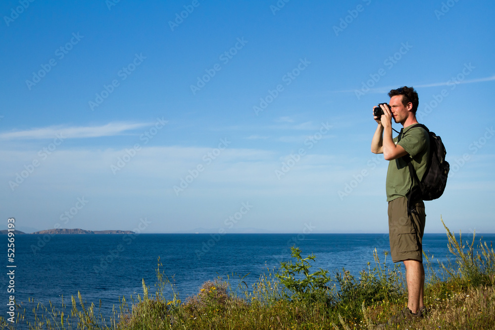 traveler with the backpack taking pictures outdoors traveler with the backpack taking pictures outdoors