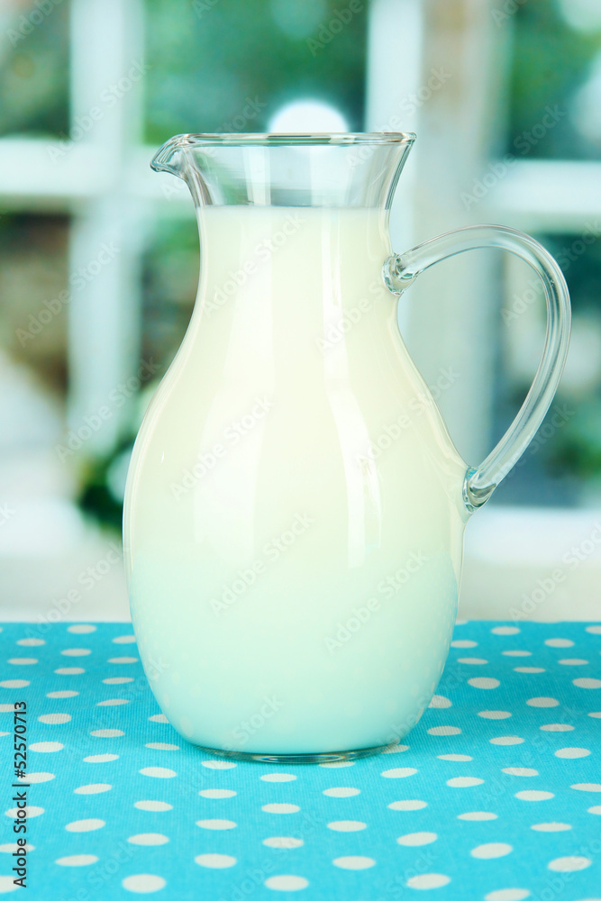Pitcher of milk on table in room Pitcher of milk on table in room