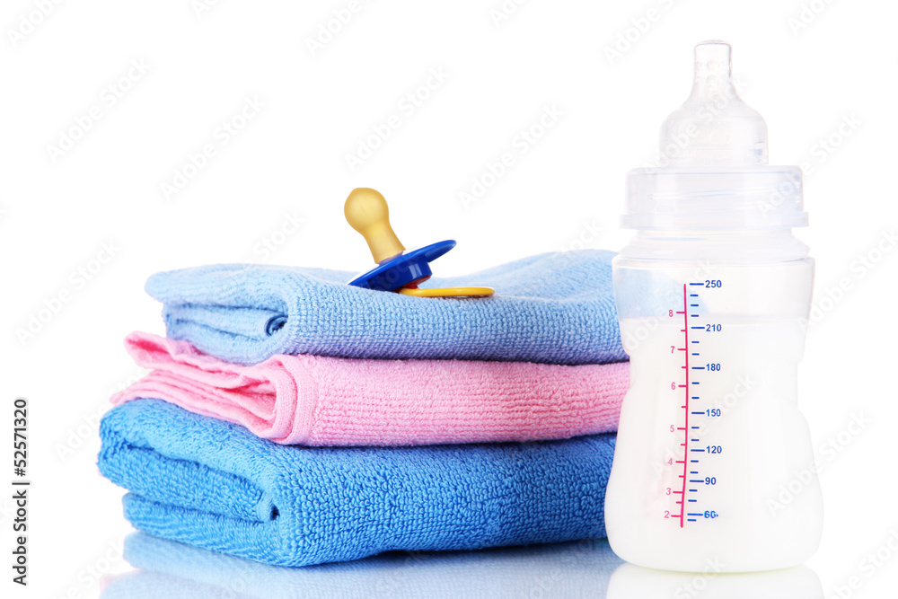Bottle for milk with towels and nipple isolated on white