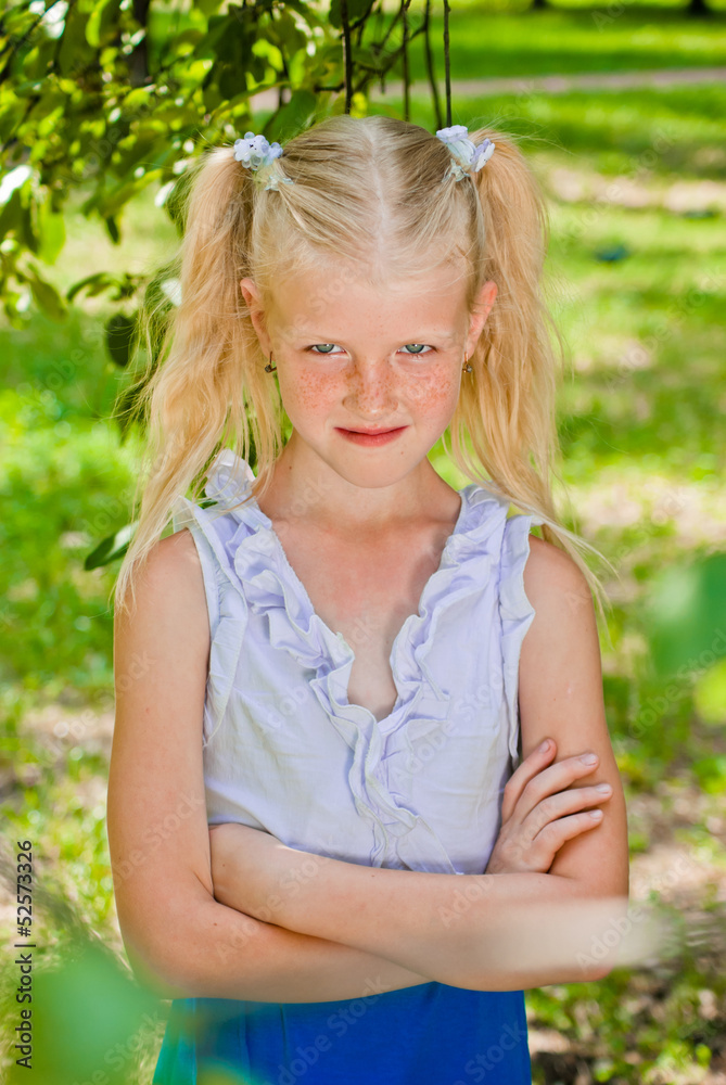 Blonde girl standing in the garden with hands clasped, conceives Blonde girl standing in the garden with hands clasped, conceives