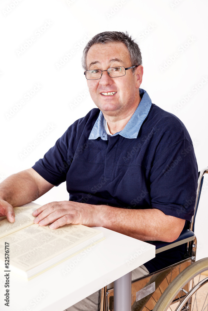 Man sitting in a wheelchair at the table Man sitting in a wheelchair at the table