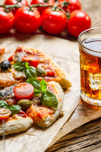 Baked pizza served with a cold drink