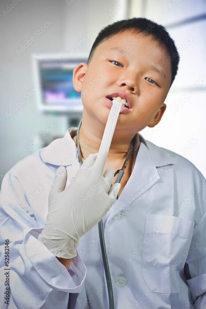 Asian boy dresses up and plays a doctor Asian boy dresses up and plays a doctor