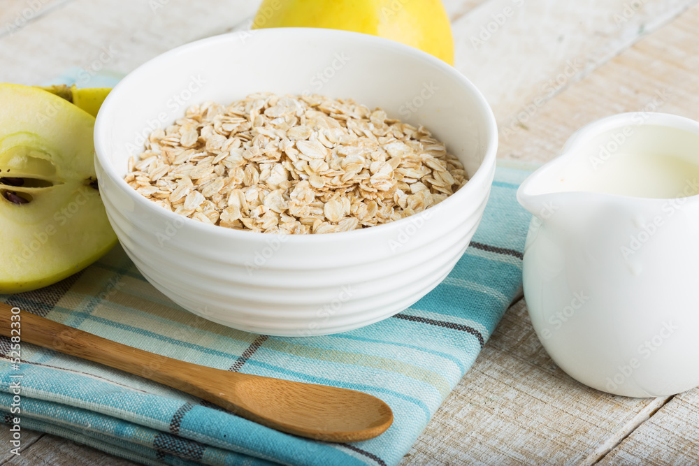 Oat flakes in bowl with apples and milk Oat flakes in bowl with apples and milk