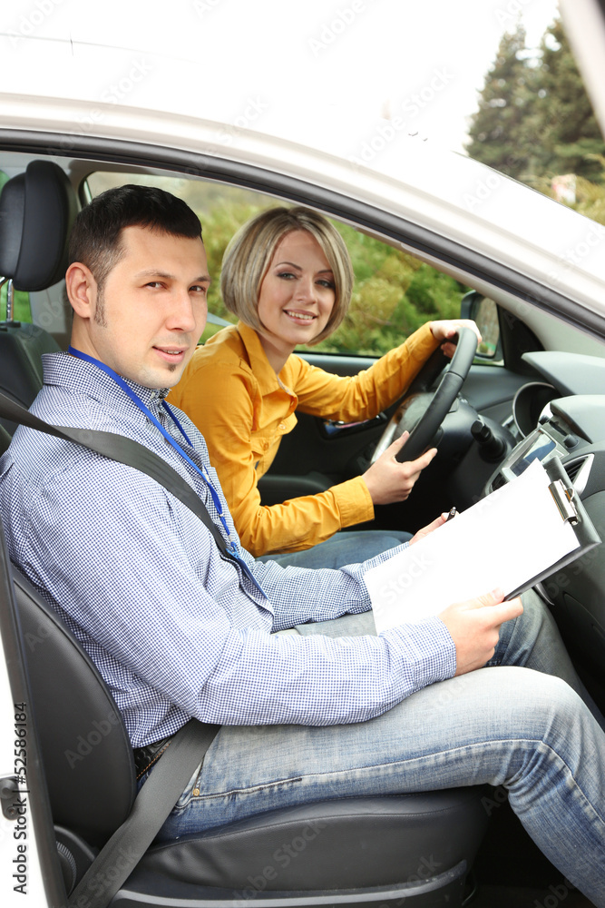 Learner driver student driving car with instructor Learner driver student driving car with instructor