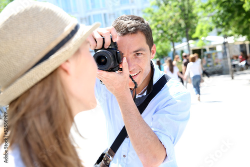 Man taking picture of girlfriend during week-end