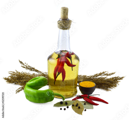 Bottle with red hot chili peppers and spices photo