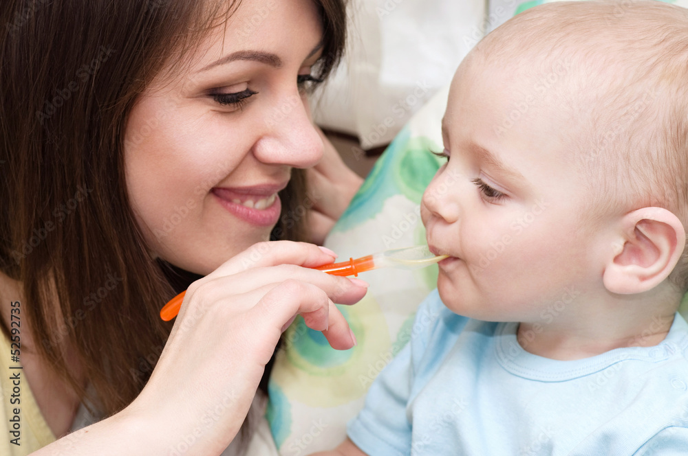 Young mother feeding baby boy Young mother feeding baby boy