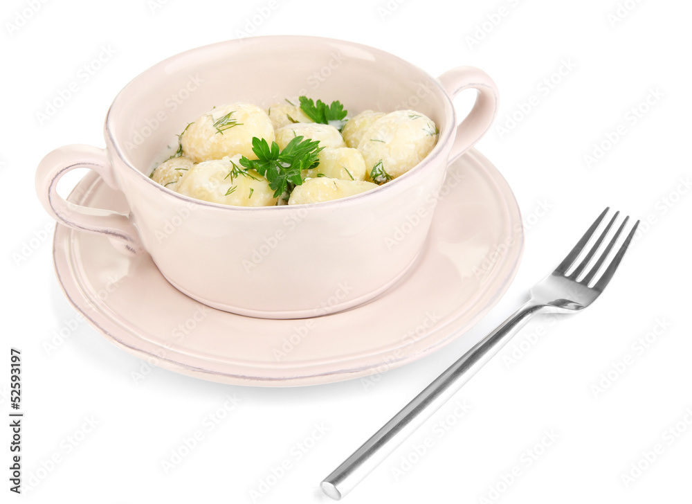 Tender young potatoes with sour cream and herbs in pan isolated Tender young potatoes with sour cream and herbs in pan isolated