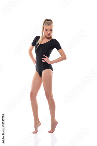 Young slim woman posing in black leotard