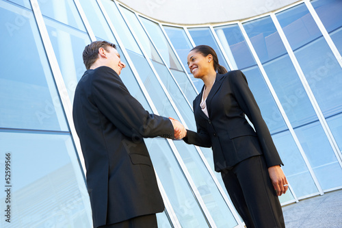 Businessman And Businesswomen Shaking Hands Outside Office © Monkey Business