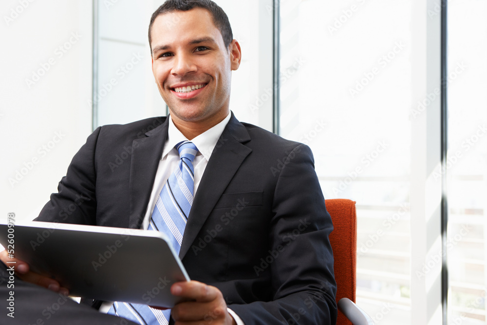 Businessman Using Digital Tablet In Office Businessman Using Digital Tablet In Office
