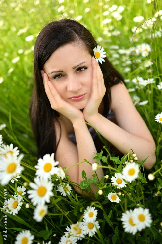 Beautiful Young Woman Outdoors. Daisy field Beautiful Young Woman Outdoors. Daisy field