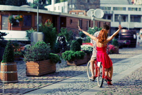Couple have fun riding on bike