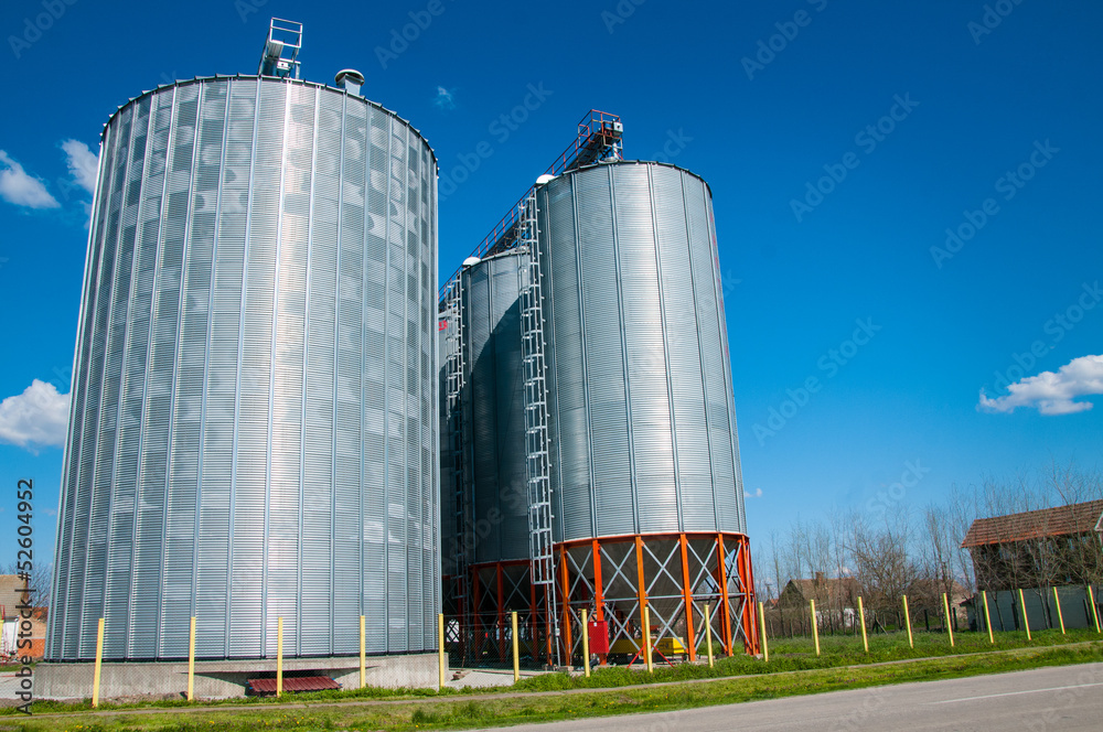 Silver Grain Silos with blue sky in background