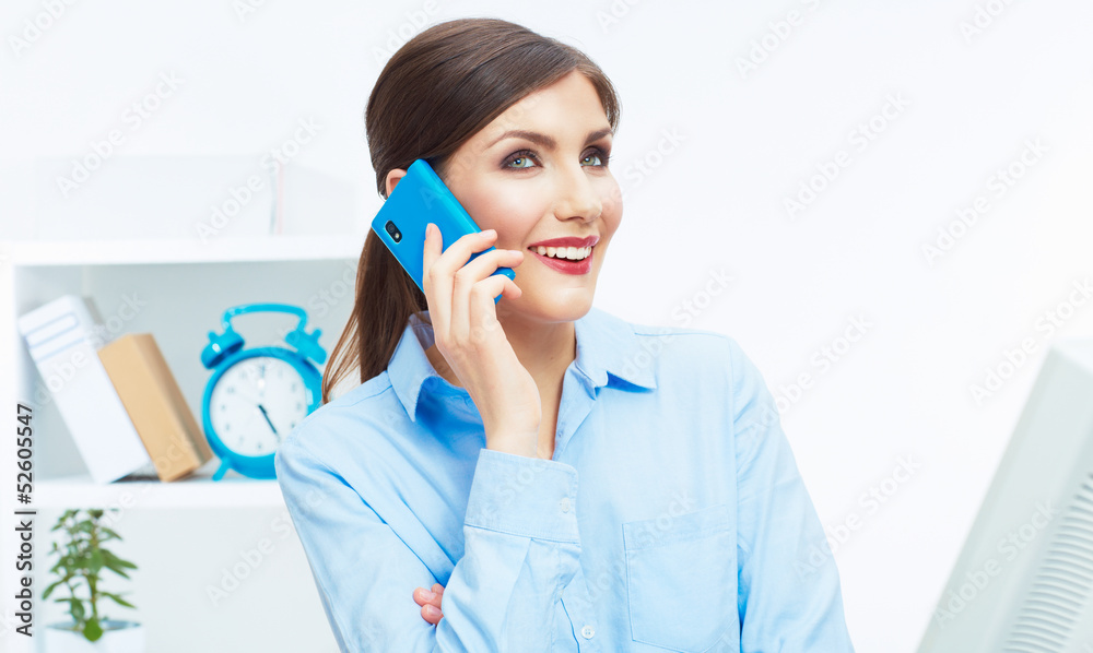 Portrait of young businesswoman in office on phone. Portrait of young businesswoman in office on phone.