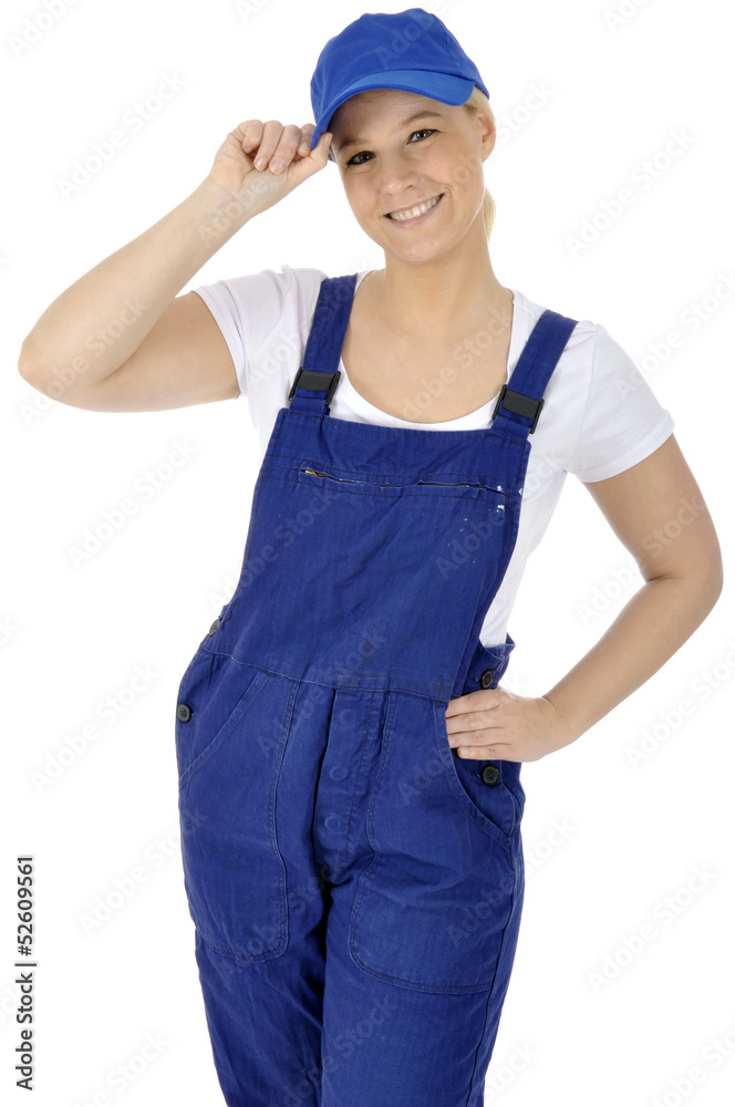 Junge freundliche Handwerkerin in Blaumann grüßt Junge freundliche Handwerkerin in Blaumann grüßt
