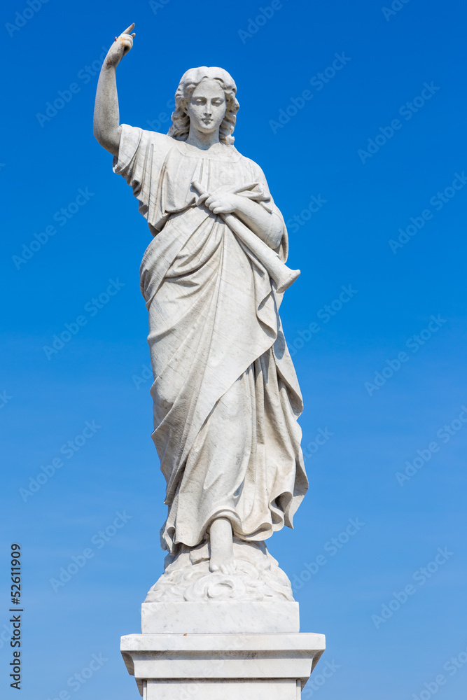 Statue of a young woman raising a finger as a judgement sign