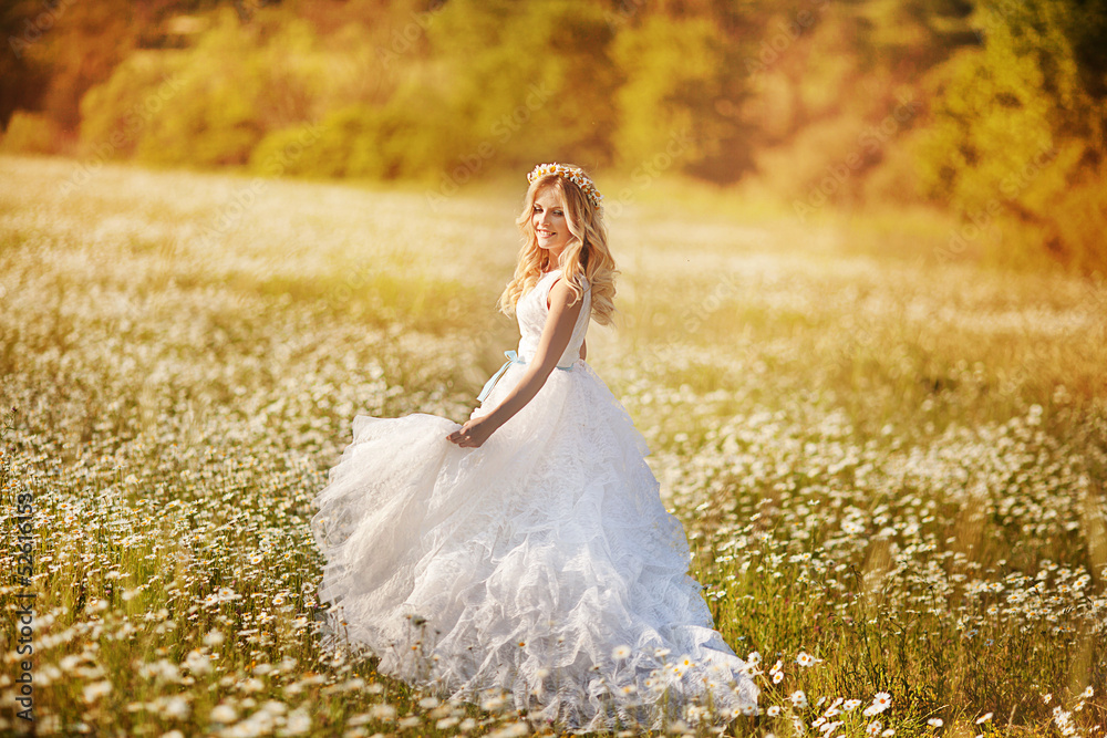 Beautiful woman enjoying daisy field